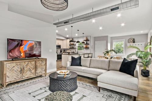 a living room with a couch and a tv at Spacious Downtown Apartment - Walk to Old Town FC! in Fort Collins
