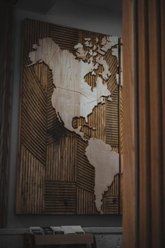 a map of the world hanging on a wall at Casa di Pino EcoLodge Hotel in Žabljak