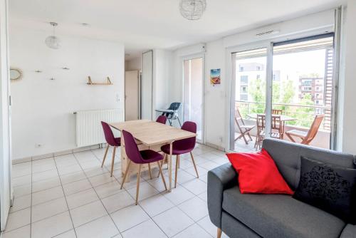 a living room with a couch and a table at La loge du Minotaure, parking et bureaux in Toulouse