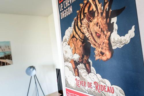 a poster of a dragon on a wall at La loge du Minotaure, parking et bureaux in Toulouse