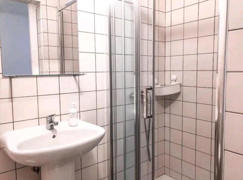 a bathroom with a sink and a shower at Sudoeste Guest House in Odeceixe