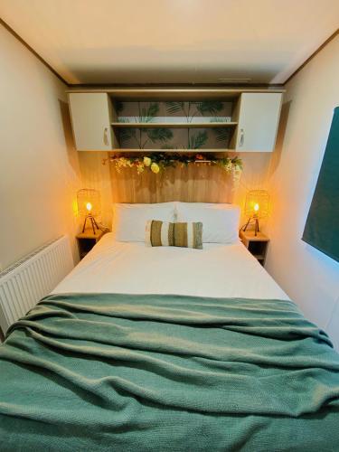 a bedroom with a large white bed with two lamps at The Sanctuary Holiday Home - Escape the Ordinary in Knaresborough