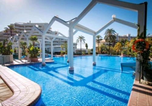 a large swimming pool with blue water in a resort at Benal Beach 229 in Benalmádena