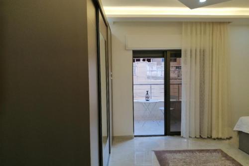 a hallway with a door leading into a room at Executive Apartments in Amman