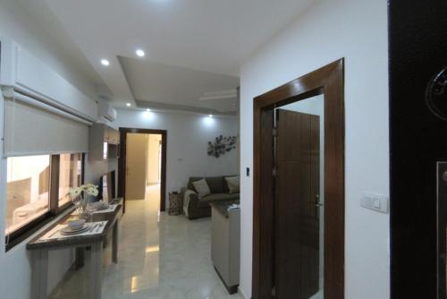 a room with a kitchen and a living room at Executive Apartments in Amman