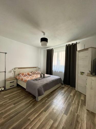 a bedroom with a bed and a wooden floor at La Mary in Old Town in Sibiu