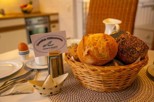 a basket of bread sitting on top of a table at Ferienwohnung Wiebke -Ferien in Almdorf in Almdorf