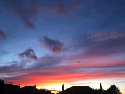 a colorful sky at sunset with clouds at Beach House Walk - Crail - Home from Home in Crail