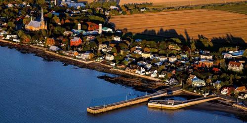 an aerial view of a town next to a body of water at Auberge Akamaraska in Kamouraska