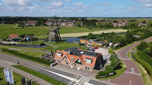 an aerial view of a house and a windmill at Millsight in Uitgeest