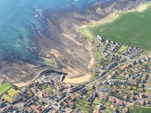 an aerial view of a town next to the ocean at Beach House Walk - Crail - Home from Home in Crail