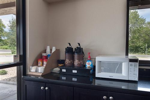 a kitchen counter with a microwave and a counter top at Red Roof Inn Springfield, IL in Springfield
