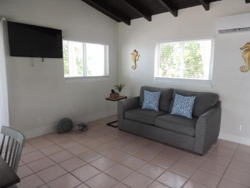 a living room with a couch and a flat screen tv at Sands of Islamorada in Islamorada