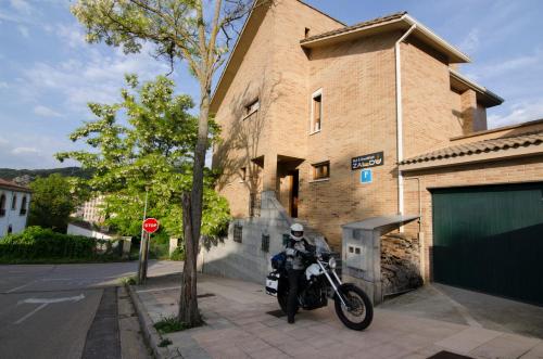 a motorcycle parked on a sidewalk in front of a building at B&B Zaldu in Estella