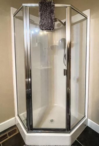 a shower with a glass enclosure in a bathroom at Jackson Creek: Downtown Jacksonville in Jacksonville