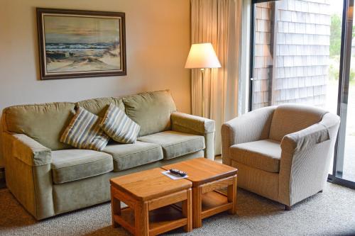 a living room with a couch and a chair and a table at Surfcrest Resort in Copalis Beach