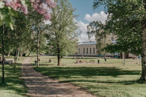 a path in a park with a building in the background at West Coast Hideaway in Pietarsaari