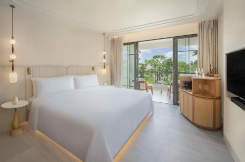 a hotel room with a large bed and a large window at Centara Reserve Samui - SHA Plus in Chaweng