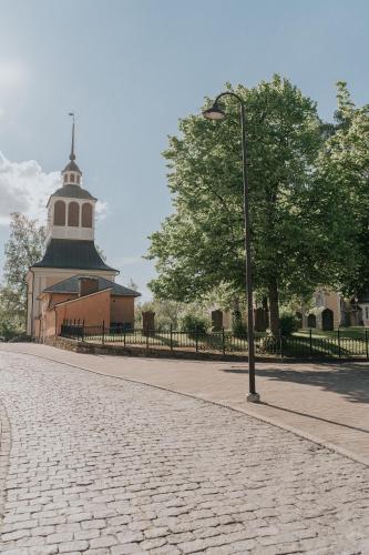 a street light next to a building with a tree at West Coast Hideaway in Pietarsaari