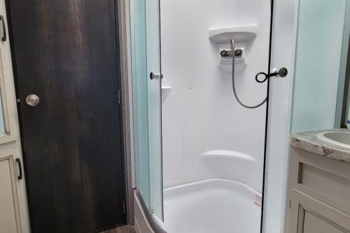 a shower with a glass door in a bathroom at Brand New RV Bay Front in Port Lavaca