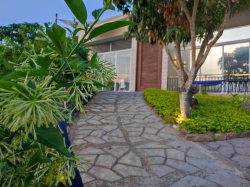 a stone walkway in front of a building with plants at Mountain View Anapoima in Anapoima