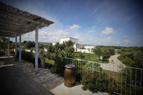 a balcony with a fence and a vase at Casale del Murgese Country Resort in Savelletri di Fasano