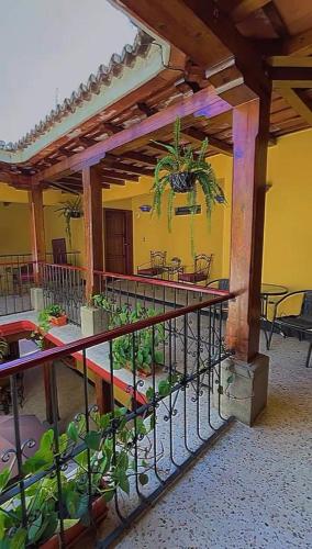 a building with a balcony with plants on it at Hotel Posada San Miguel in Antigua Guatemala