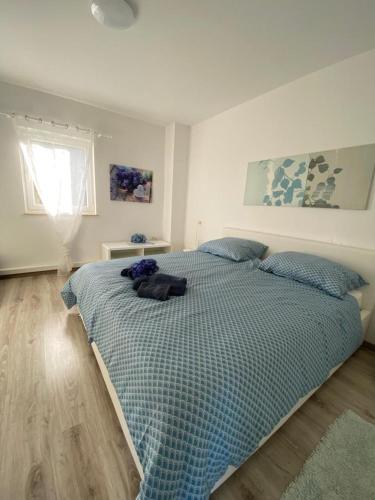 a bedroom with a bed with a cat laying on it at Casa Bellavista in Nerezine