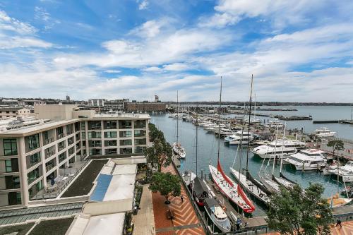 a marina with boats in the water and buildings at The Penthouse in Auckland