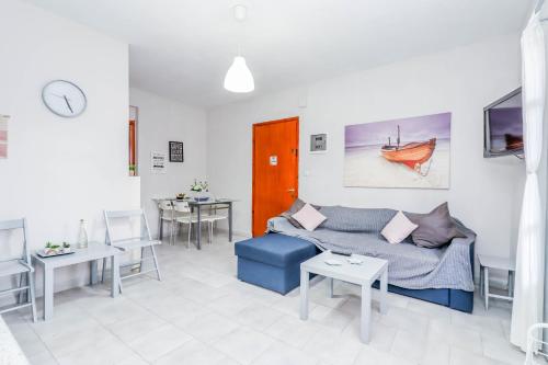 un soggiorno con divano blu e tavoli di Calma Luxury Apartments #3 Sozopoli in Halkidiki a Sozopoli