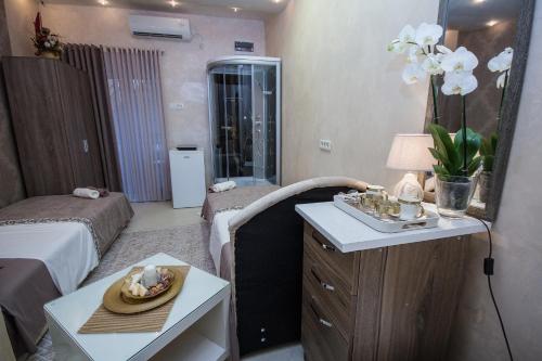 a room with a bed and a table with a mirror at Apartments Lidija in Petrovac na Moru