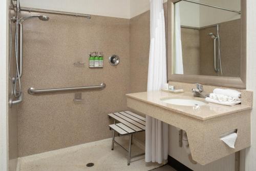 a bathroom with a sink and a shower at Holiday Inn & Suites Goodyear - West Phoenix Area by IHG in Goodyear