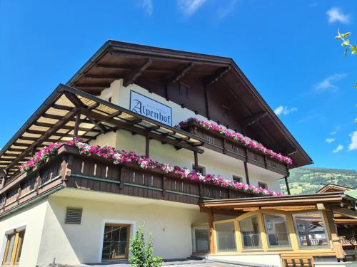 a building with flowers on the side of it at Hotel Alpenhof*** in Kaltenbach