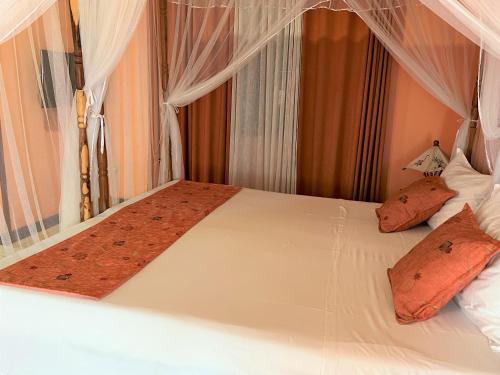 Un ou plusieurs lits dans un hébergement de l'établissement Victory Hotel & Restaurant Tulear