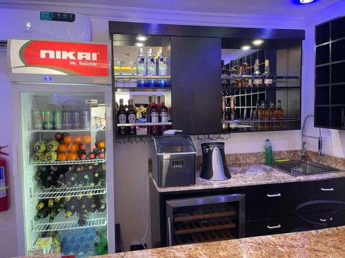 een keuken met een koelkast gevuld met veel drankjes bij LUXOL HOMES&SUITES in Ikeja