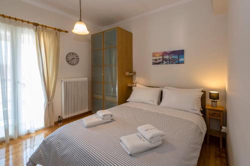 a bedroom with a bed with two towels on it at Pausa Verde in Corfu city in Corfu Town