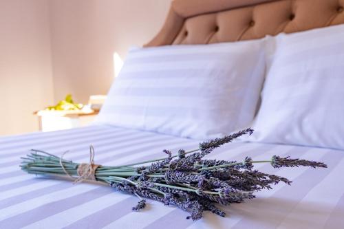 a bouquet of lavender sitting on top of a bed at Pelagia Apartments in Koroni