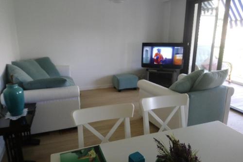 a living room with two couches and a tv at Spacious 70 m flat with Balcony and sea view! in Cannes