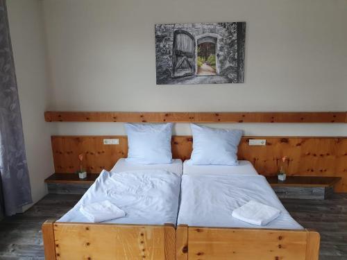 two twin beds in a room with a picture on the wall at Stay2Night Hotel in Dillingen an der Saar