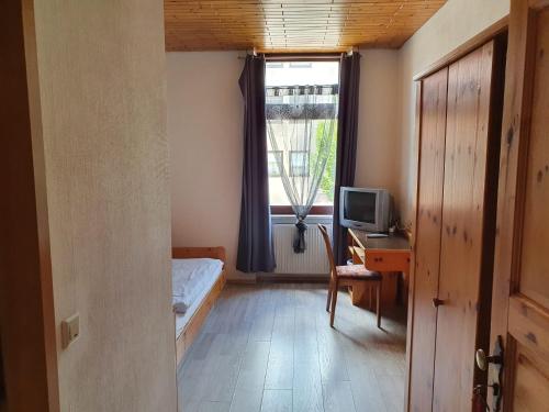 a small bedroom with a bed and a window at Stay2Night Hotel in Dillingen an der Saar