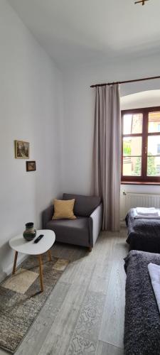 a living room with a couch and a table at SUKIENNICE MIĘDZYLESIE in Międzylesie