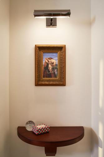 a painting on a wall with a wooden table at Virgin Hotels New Orleans in New Orleans