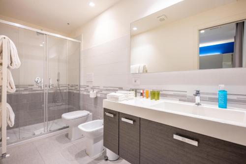 un bagno con lavandino, WC e doccia di Amarina Suite Emotion a Marina di Pietrasanta