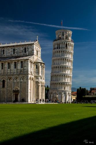 a leaning tower next to a building with a green field at IL NIDO DI CHLOE cod. citra 011027-LT-0239 in Sarzana