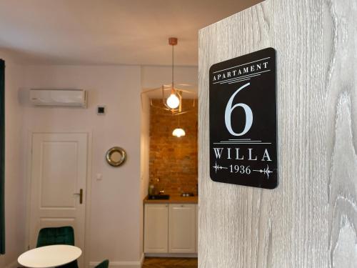 a sign on the side of a wall in a room at Willa 1936 , Parking in Toruń