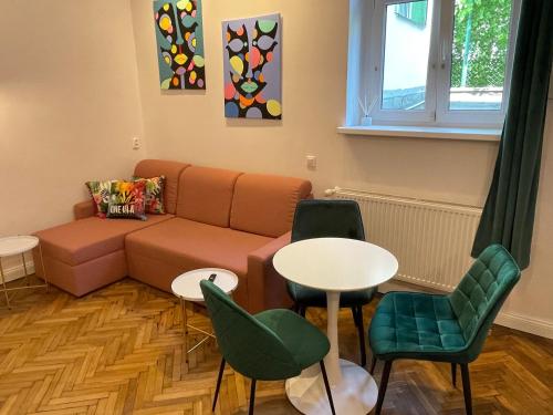 a living room with a couch and a table and chairs at Willa 1936 , Parking in Toruń