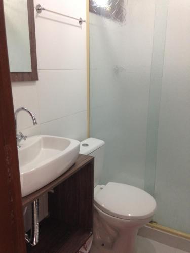 a bathroom with a sink and a toilet at Pousada Familia Quandt in Guarda do Embaú