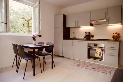 a kitchen with a table and chairs and a window at Lake & rest in Riva del Garda