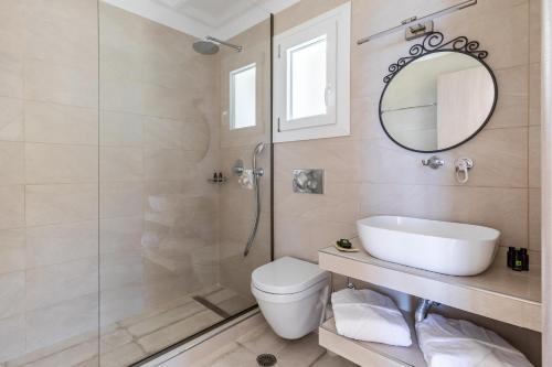 a bathroom with a shower and a toilet and a sink at Liagka Villa in Skopelos Town