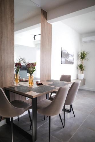 a dining room with a wooden table and chairs at Allure Apartments in Ulcinj